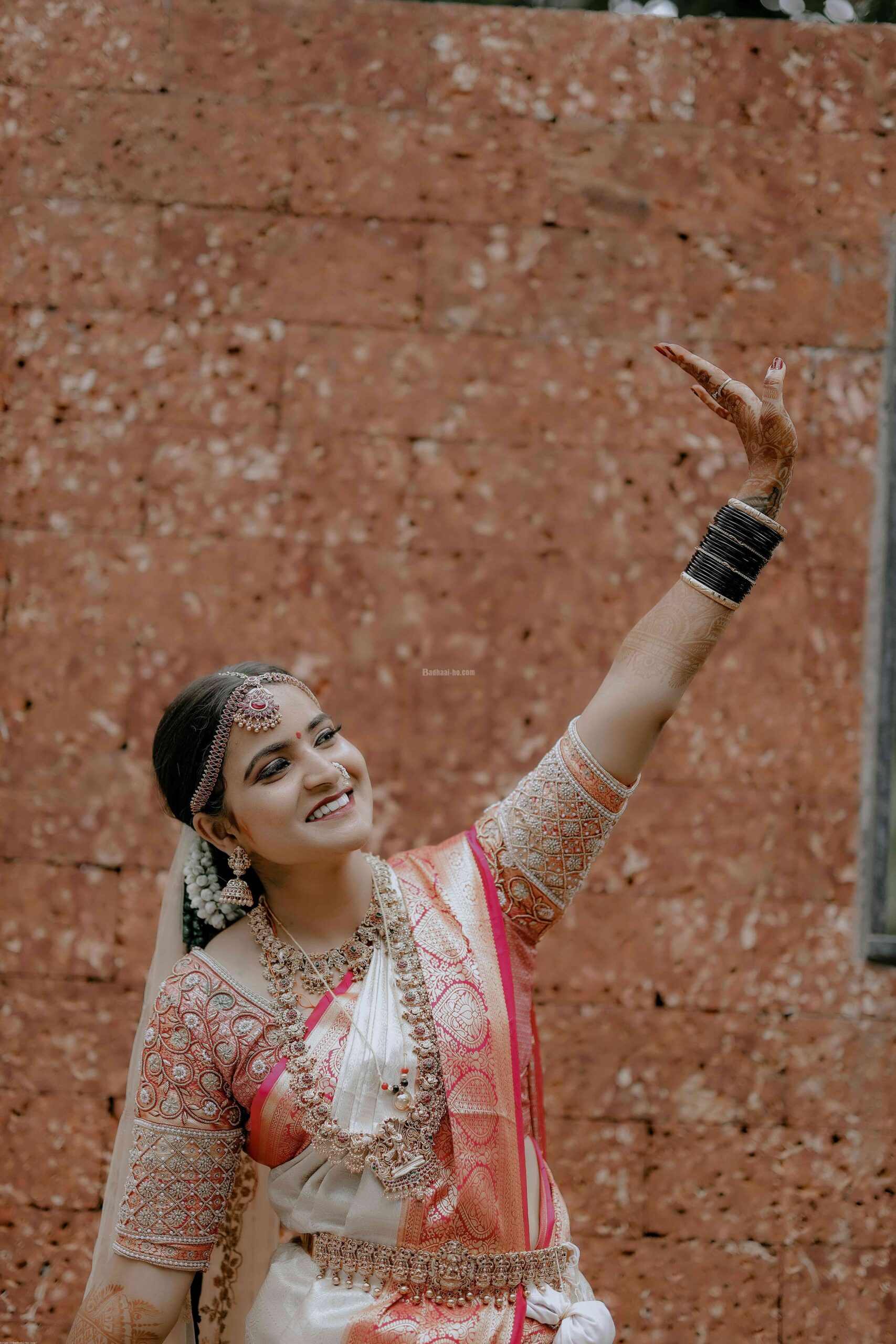 free_photo_of_smiling_young_woman_in_traditional_wedding_dress